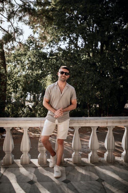 Stylish Man in Beige Polo and Sunglasses