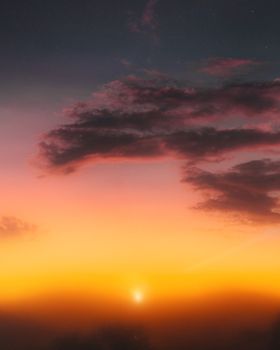 Vibrant sunset with dramatic clouds and colorful sky, perfect for nature and travel themes.
