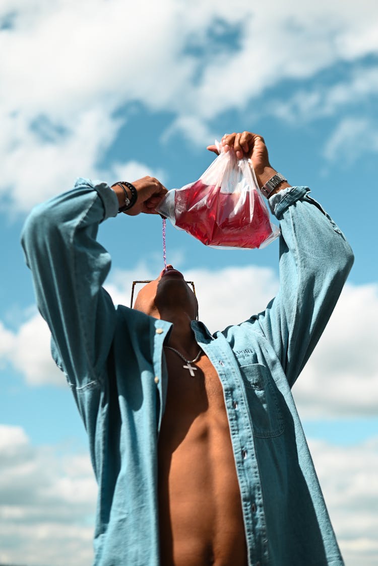 Man Drinking From Plastic Bag