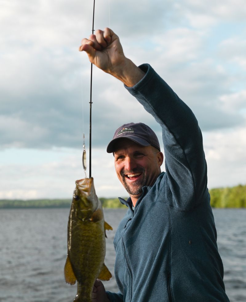 A happy angler with rod and fresh catch