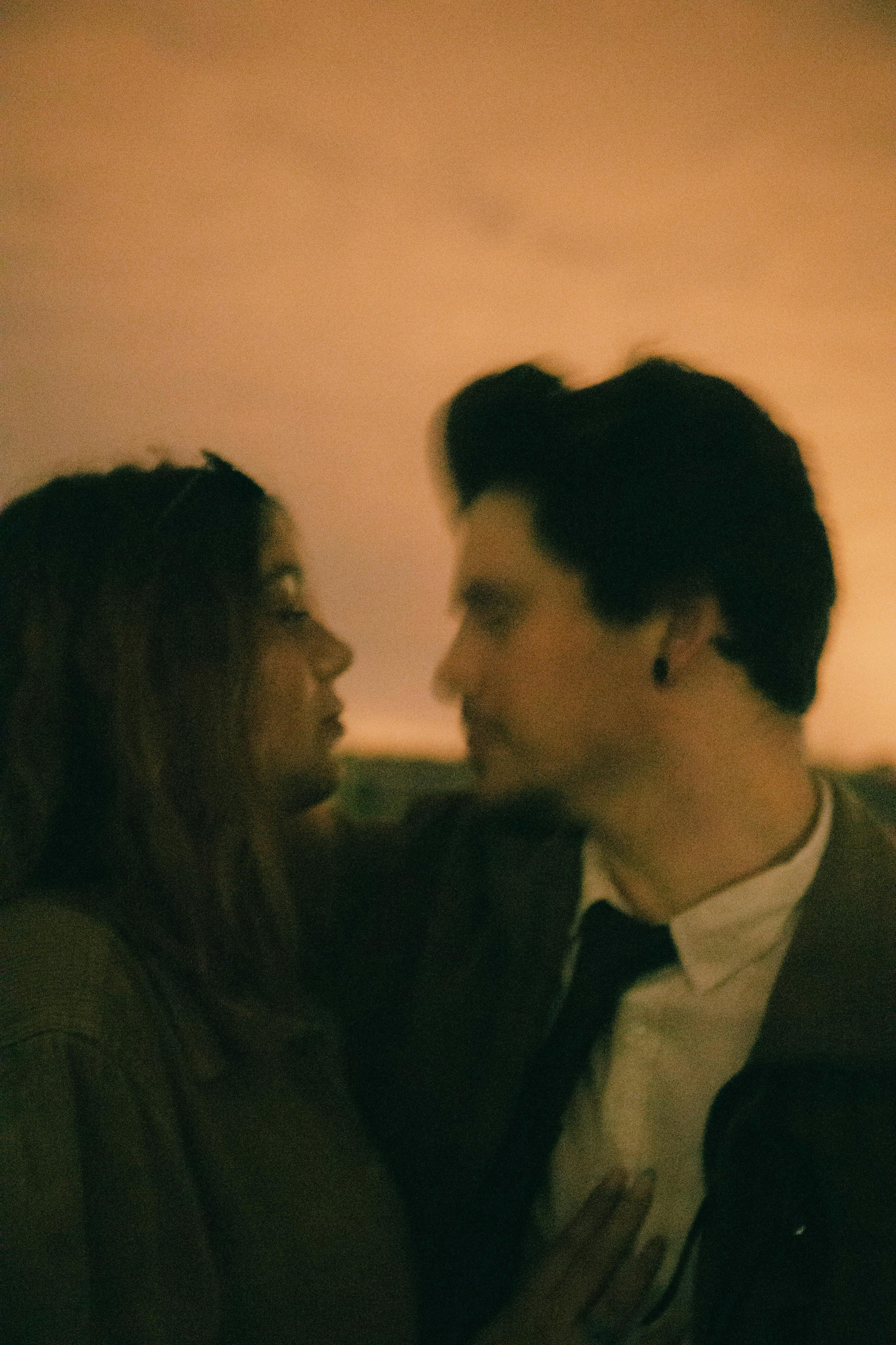 An artistic, blurred image of a couple embracing, evoking romance and intimate connection.