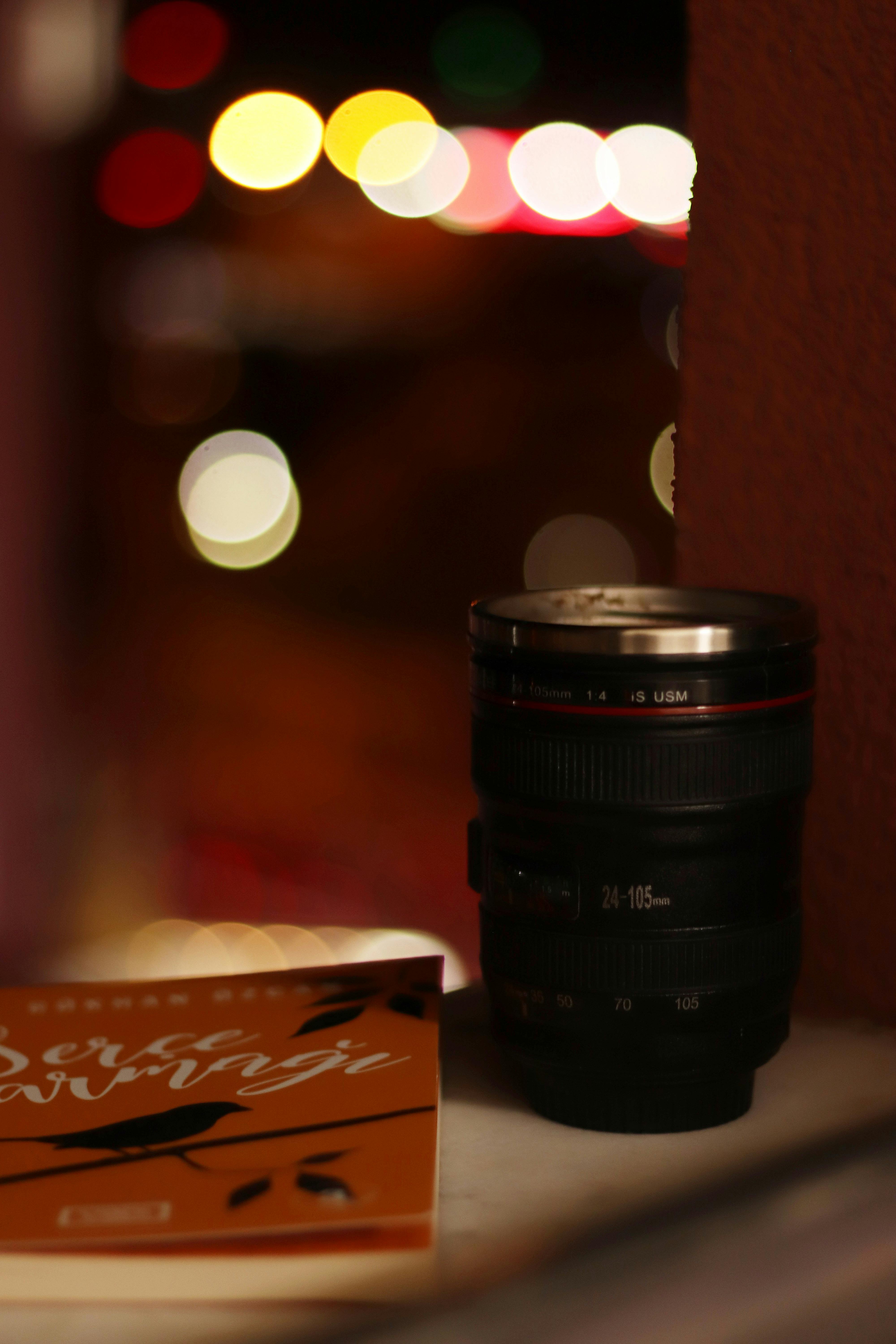 Black Camera Lens Near a Book · Free Stock Photo