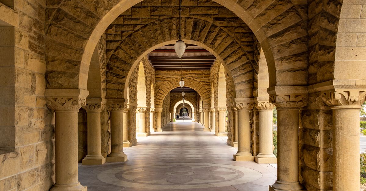 Elegant stone archway corridor at Stanford University, a perfect blend of history and architecture.