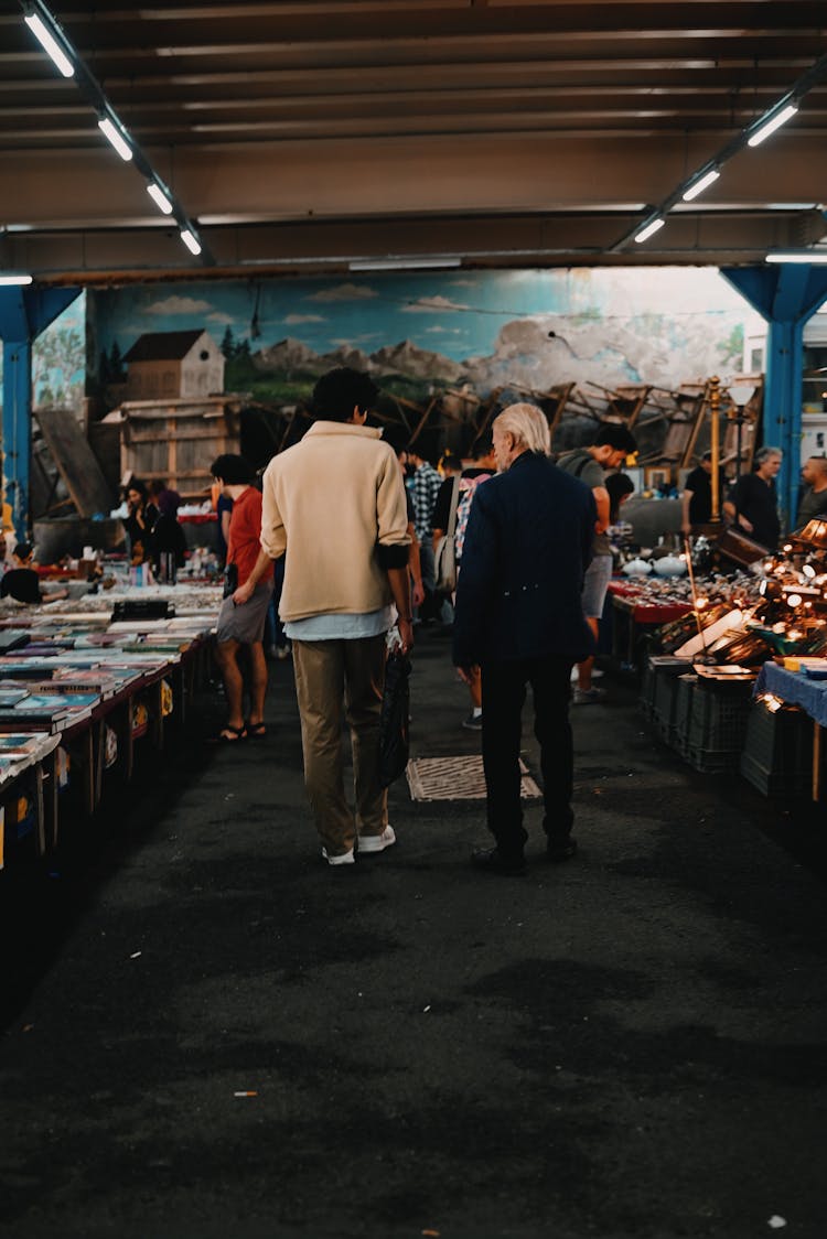 People Walking Through A Market 