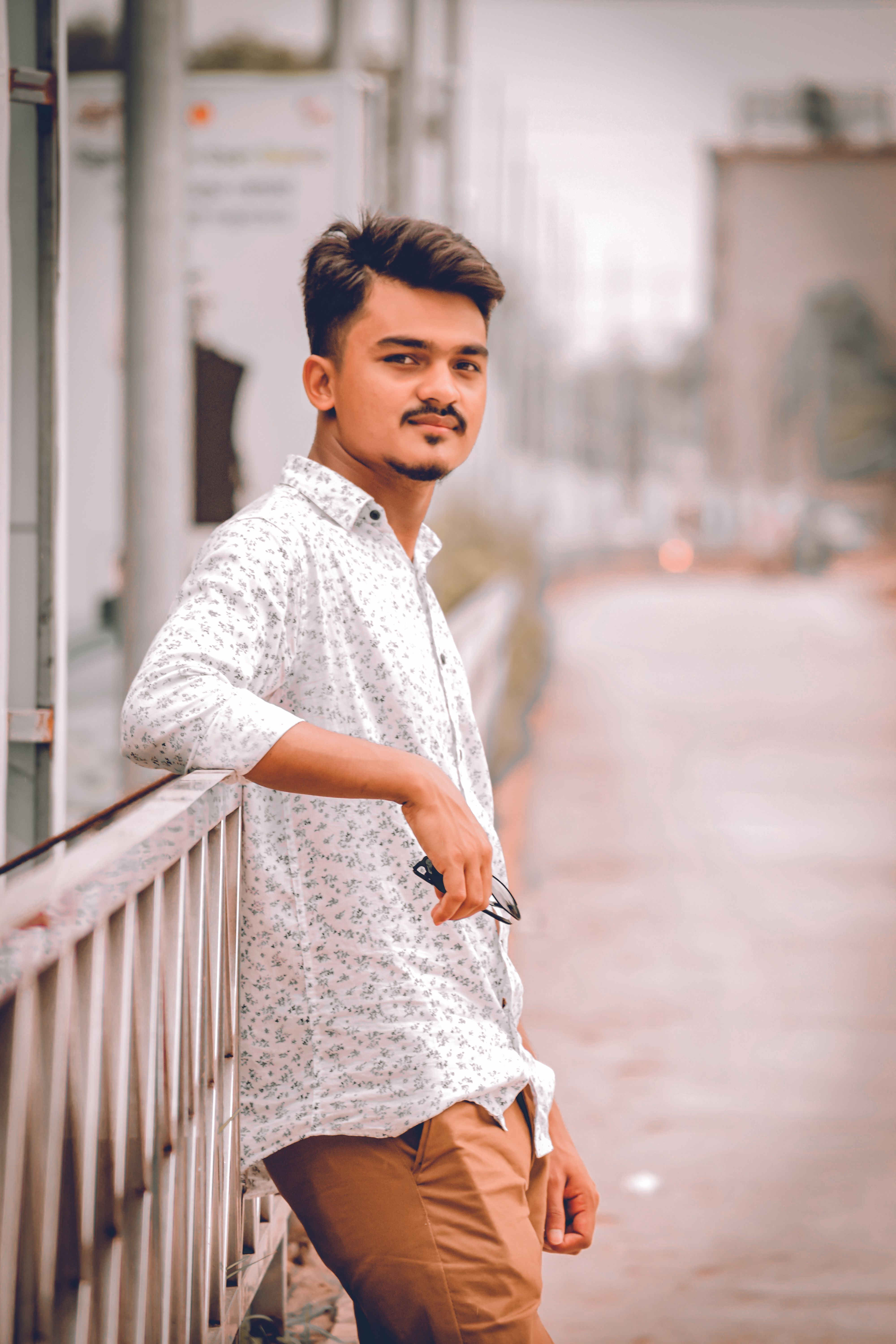 Stylish young man posing confidently in Dhaka street. Modern and fashionable portrait.