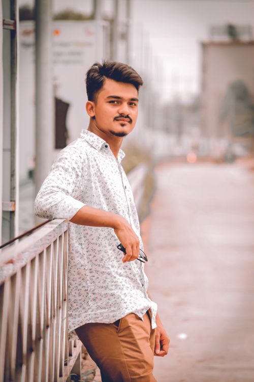 Free Stylish young man posing confidently in Dhaka street. Modern and fashionable portrait. Stock Photo