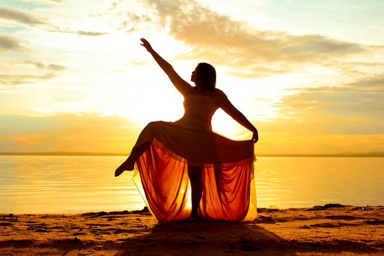 Woman Dancing On The Beach 