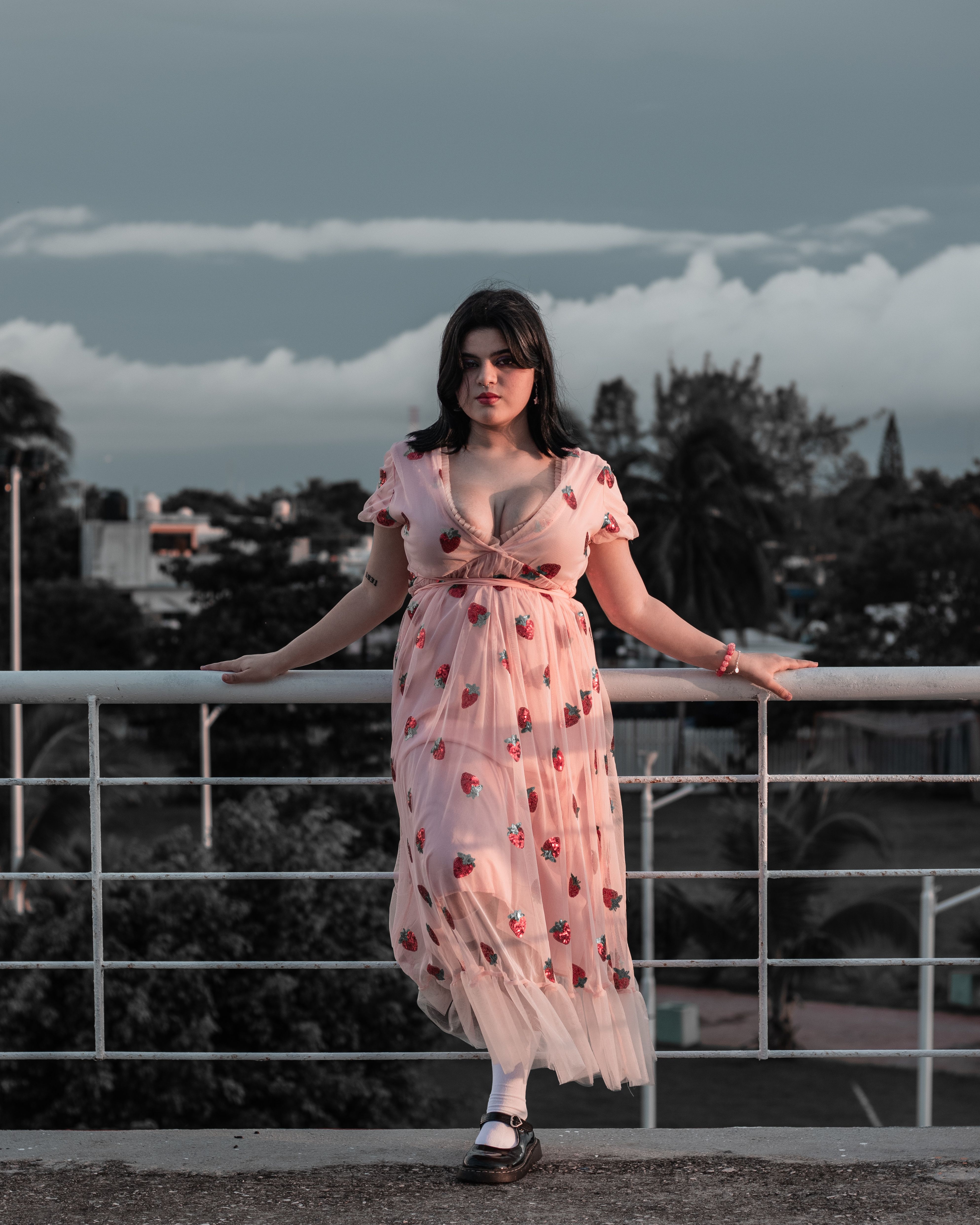 Woman in Pink Dress leaning on Metal Railing · Free Stock Photo