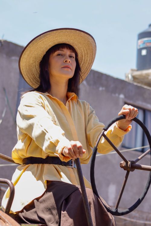 Free Portrait of a woman in a straw hat driving a tractor in Ciudad de México on a sunny day. Stock Photo