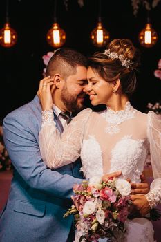 Beautiful moment of a newlywed couple embracing and smiling during their wedding celebration.