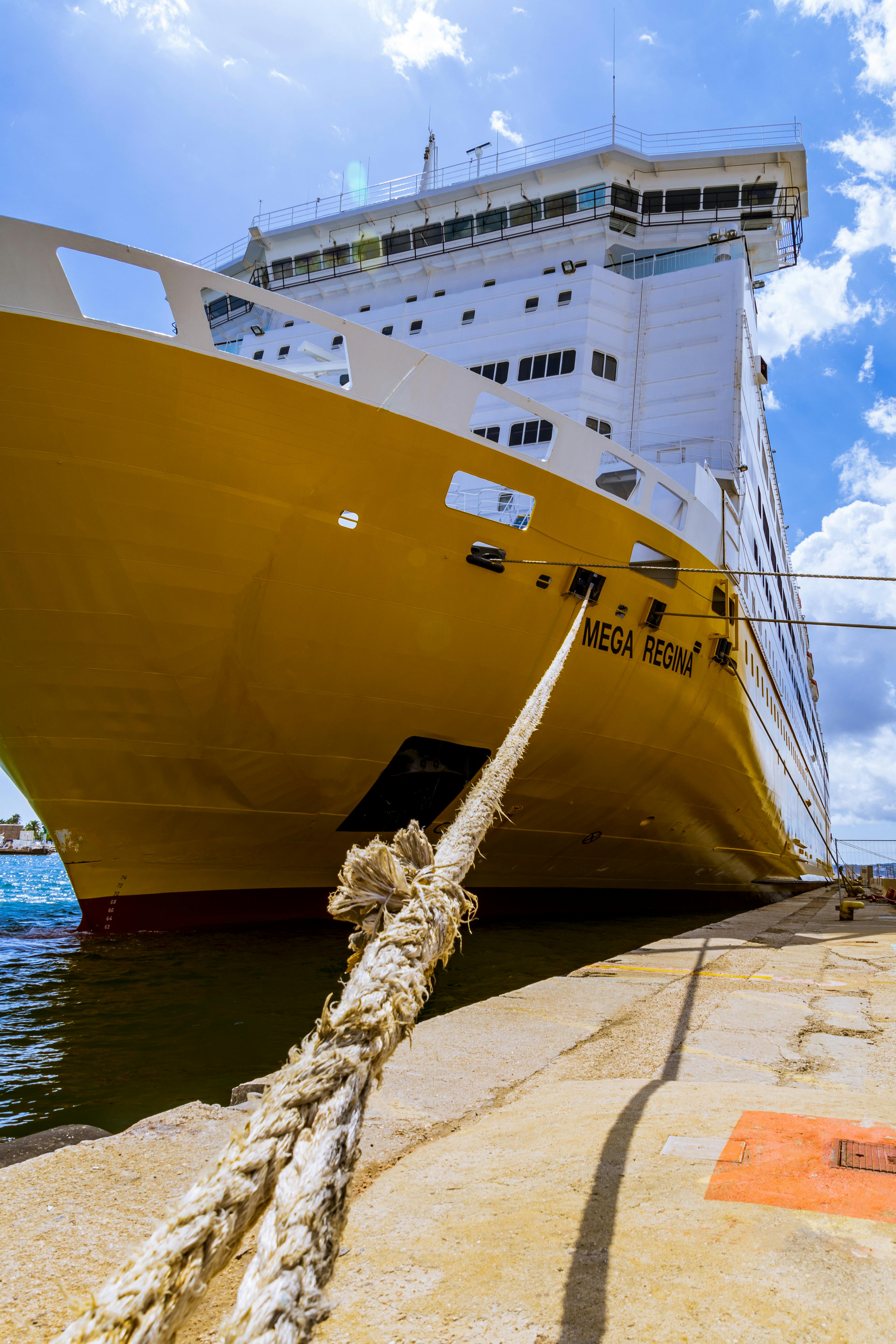 Dynamic low-angle view of a large yellow vessel docked at Toulon, France.