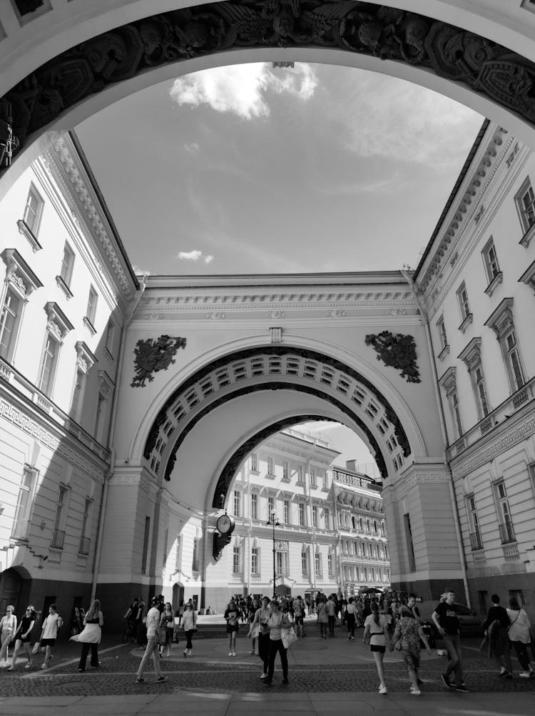 People Walking Near Old Historic Building On City Street