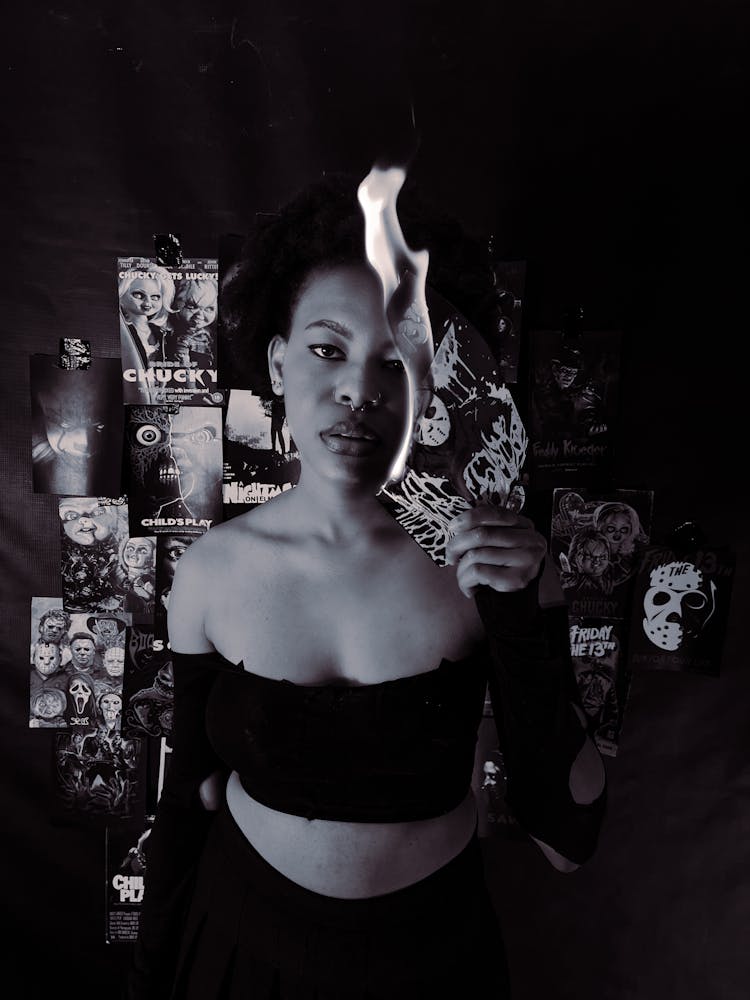 Woman Holding A Burning Photograph 