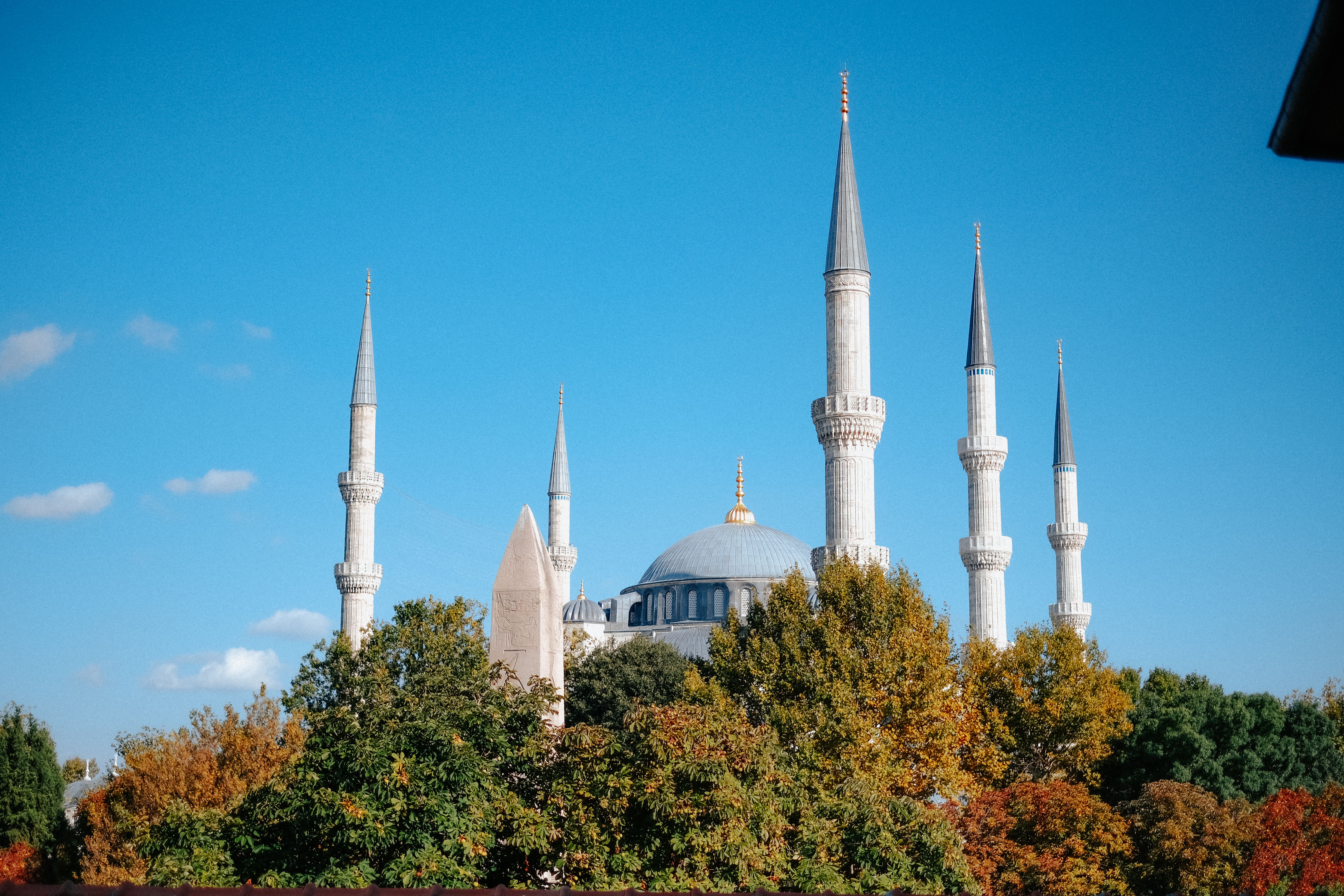 Mosque Hidden in Trees and Minarets against Blue Sky · Free Stock Photo