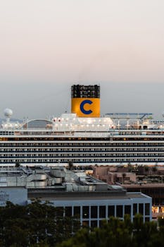 Large luxury cruise ship docked at İstanbul harbor at dusk, symbolizing elegance and travel.