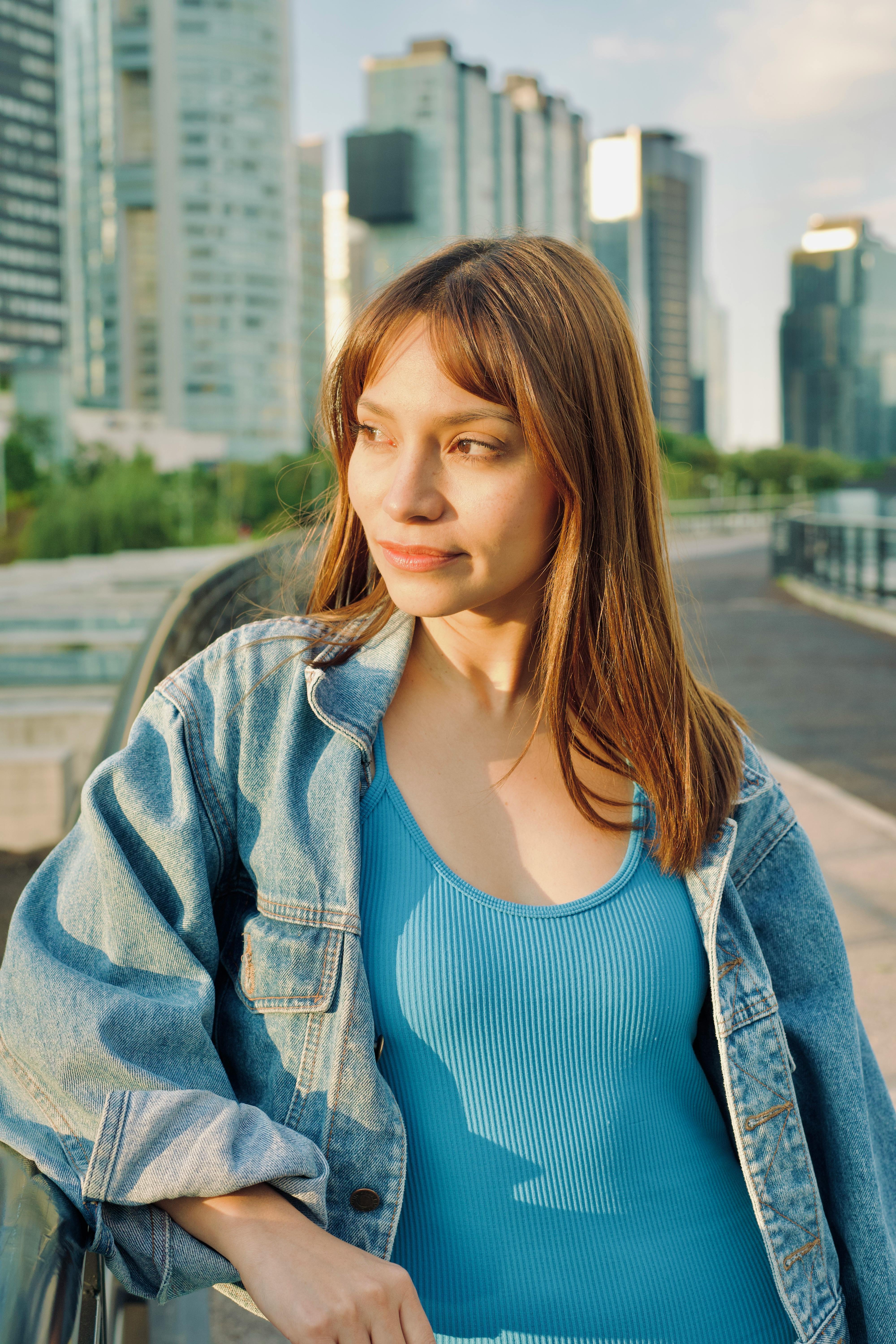 Woman in Red Tank Top and Blue Denim Jeans Smiling · Free Stock Photo