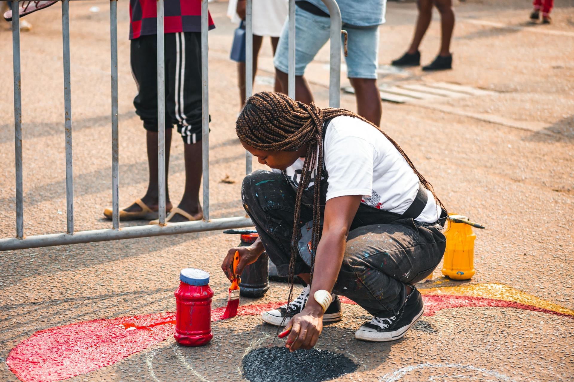 A talented street artist paints a vibrant mural in Accra, showcasing creativity and culture.