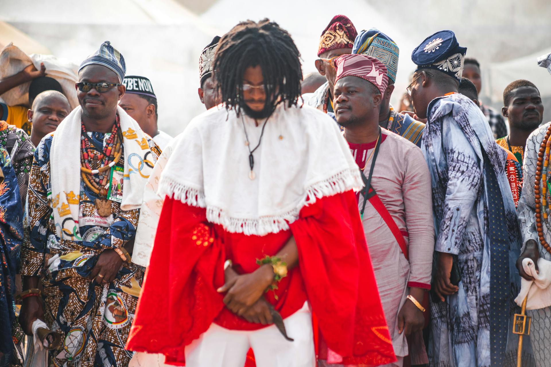 Vibrant cultural celebration in Accra with men in traditional Ghanaian attire.