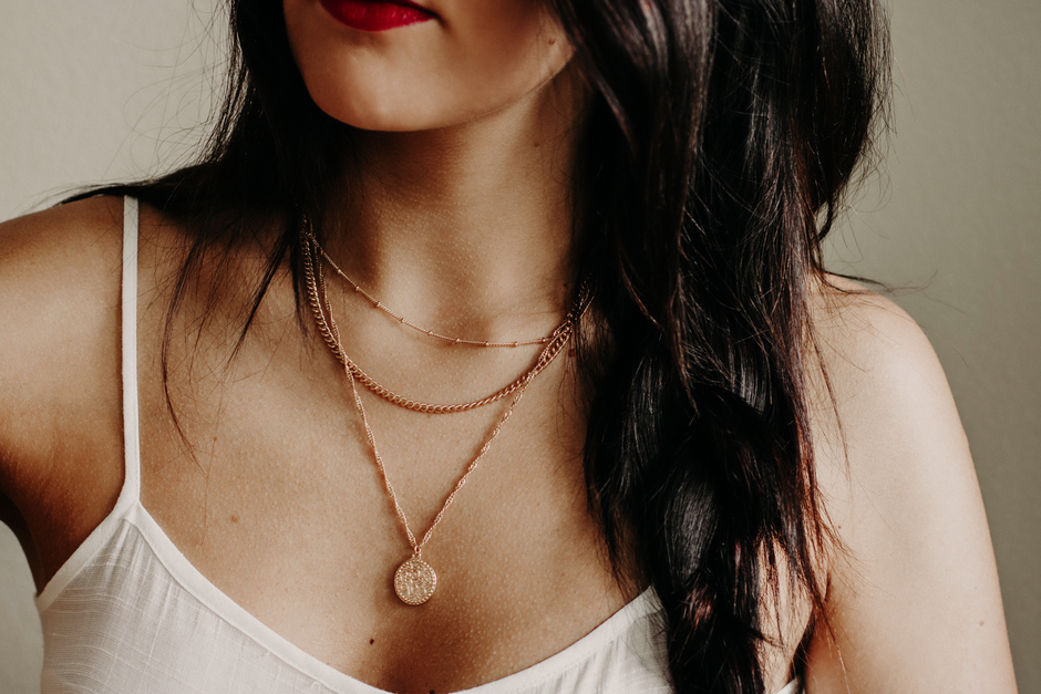 A woman wearing a minimalist gold chain, demonstrating the layering trend - 1 gram gold jewellery shop near me A woman wearing a minimalist gold chain, demonstrating the layering trend - 1 gram gold jewellery shop near me