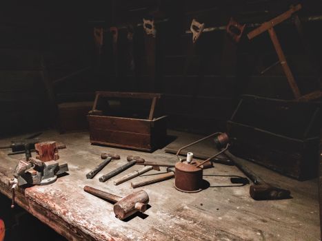 Dark Studio with Rusted Hammers and Handsaws
