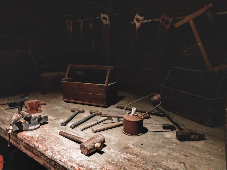 Dark Studio With Rusted Hammers And Handsaws