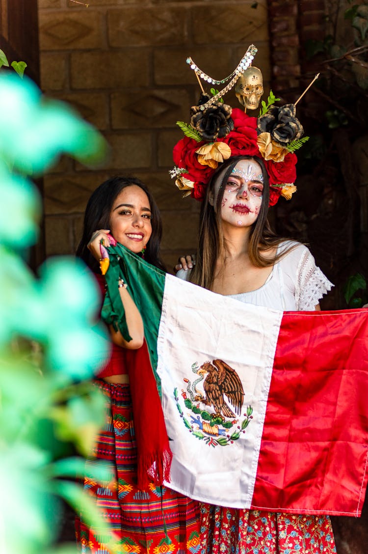 Teenage Girls Standing In Their Traditional Wear Holding A Mexico Flag