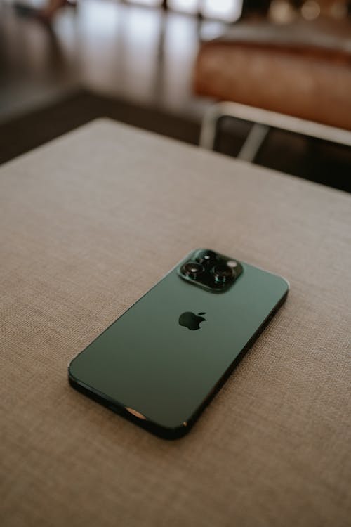 Close-Up Shot of a Smartphone on Brown Surface