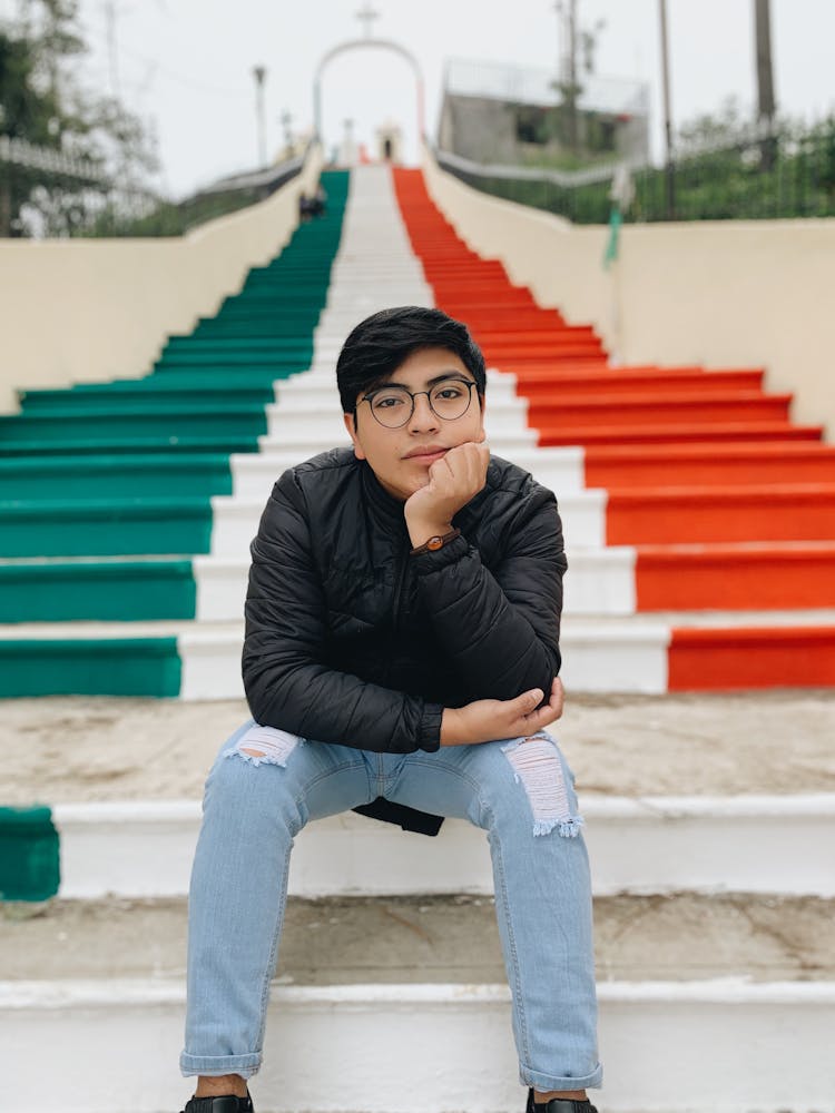 Man In Black Leather Sitting On Steps