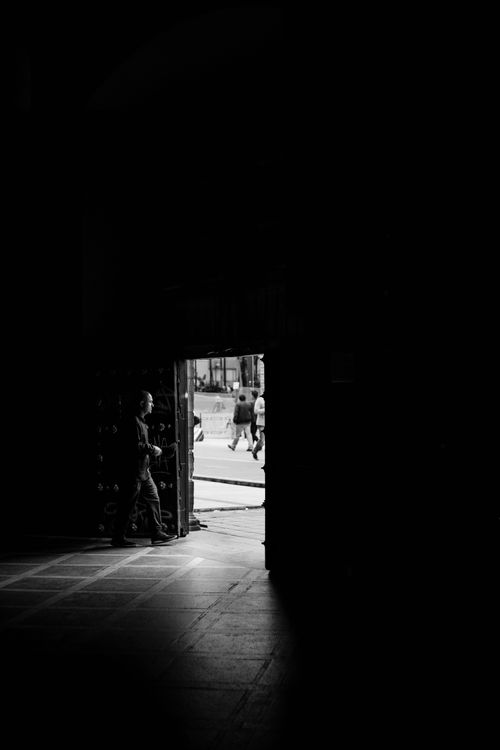 Free Black and white photo of a person in a doorway in Bogotá, Colombia. Stock Photo