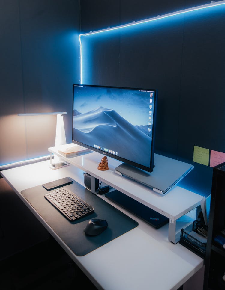 Computer Monitor With Keyboard And Mouse On Office Desk