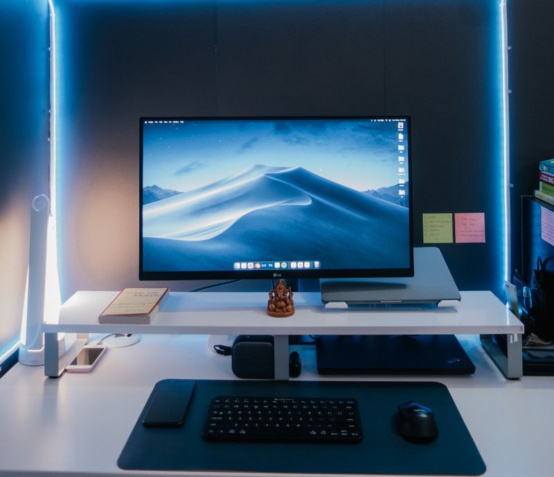 rolling storage bins tucked under a standing desk