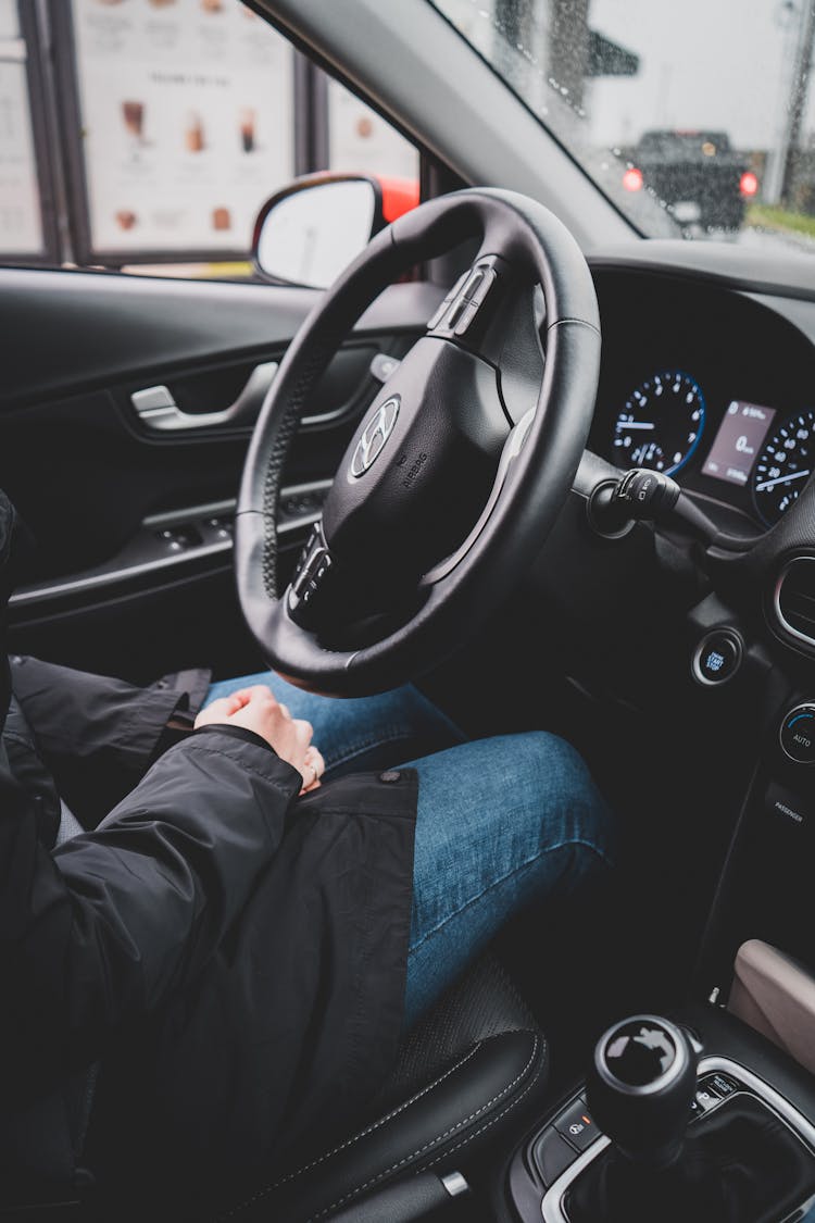 A Person Sitting On Driver Seat