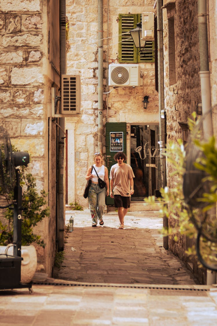 Man And Woman Walking On Alley