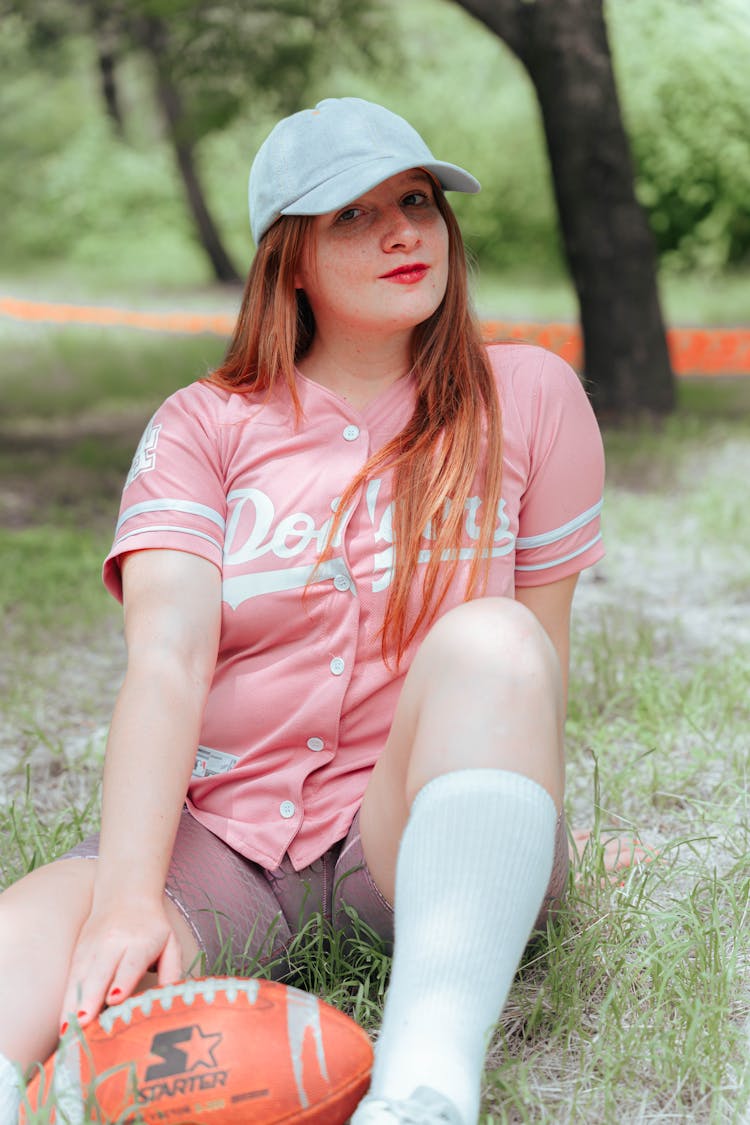 Woman In Cap Posing With Ball