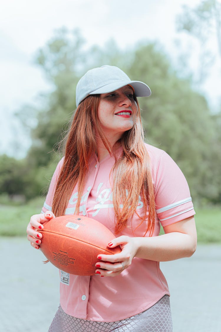 A Woman Holding A Football