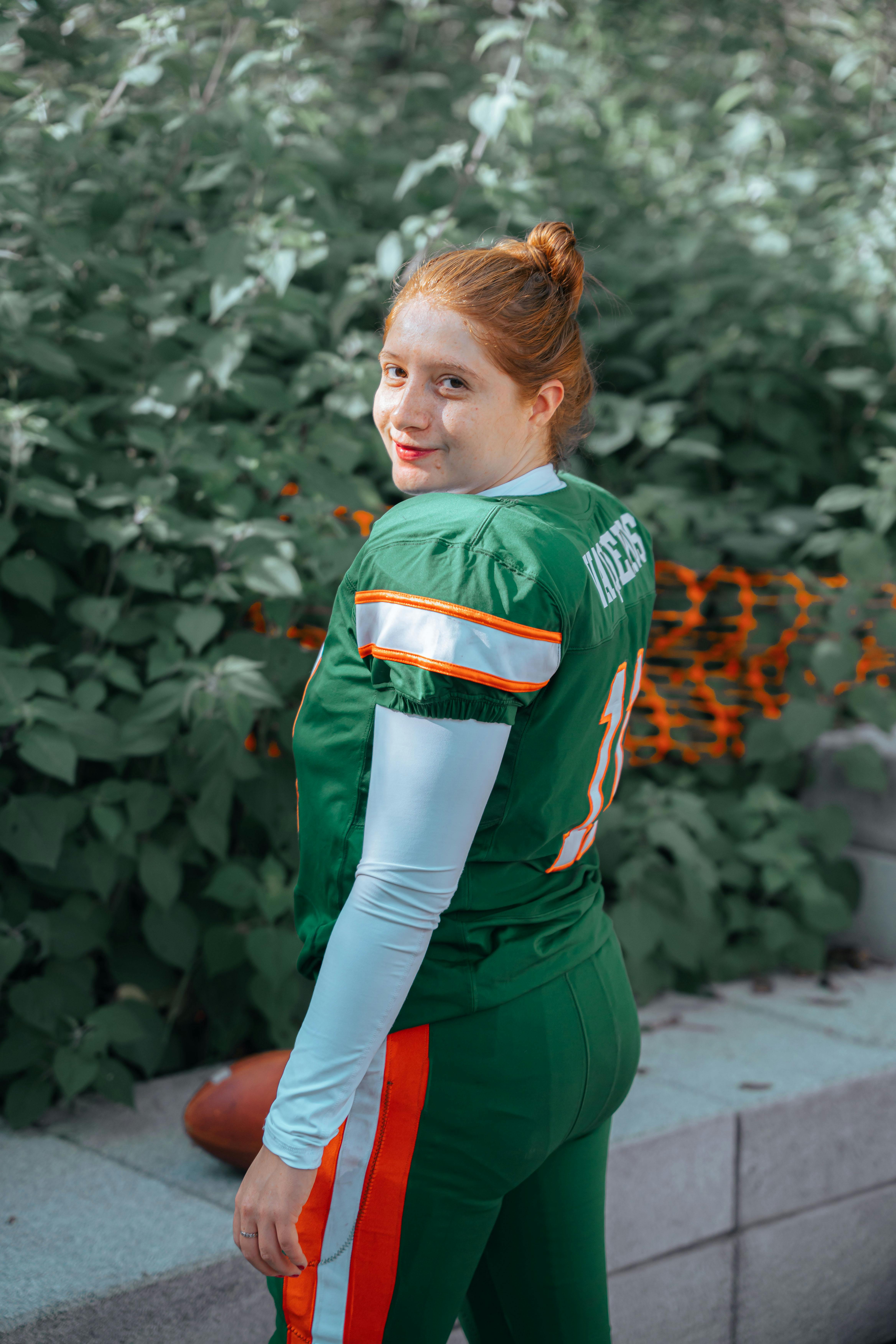 A Woman Wearing a Green Football Uniform · Free Stock Photo