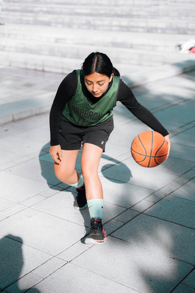 Woman Dribbling A Ball