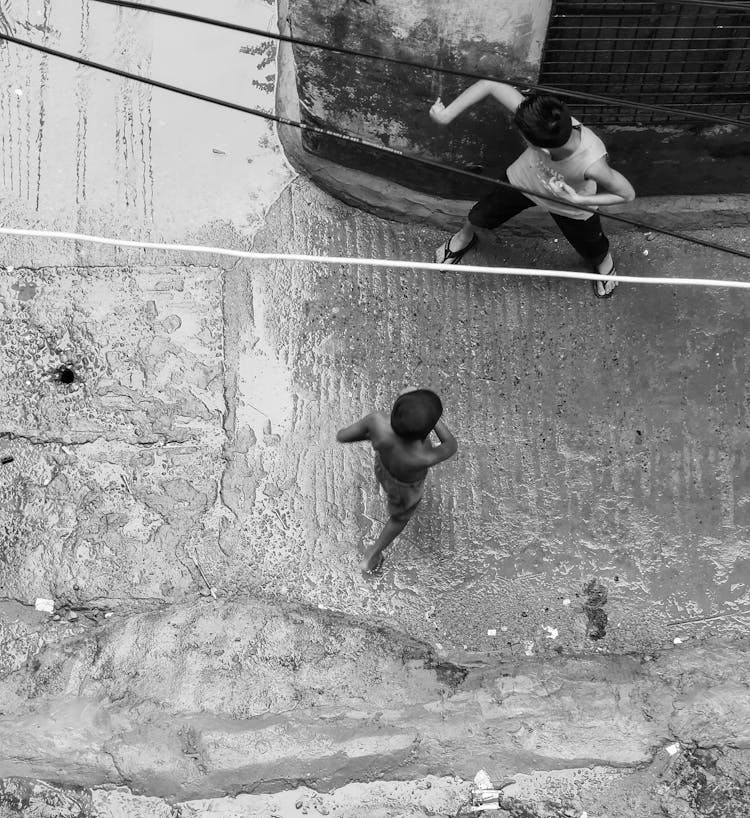 Boys Child Playing On A Street