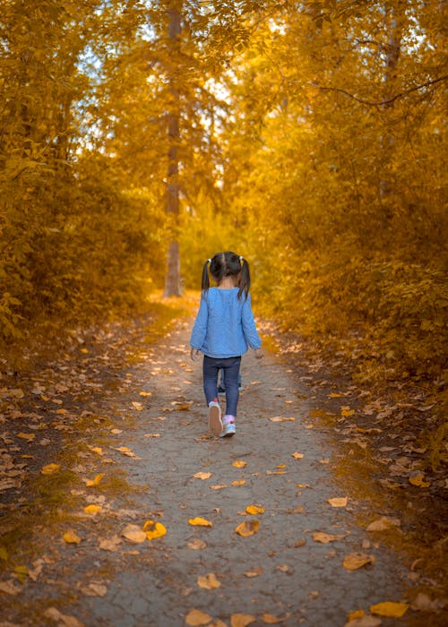 Girl Walking on Pathway