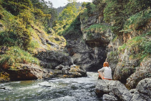 Woman on Rock Near to Body of Water