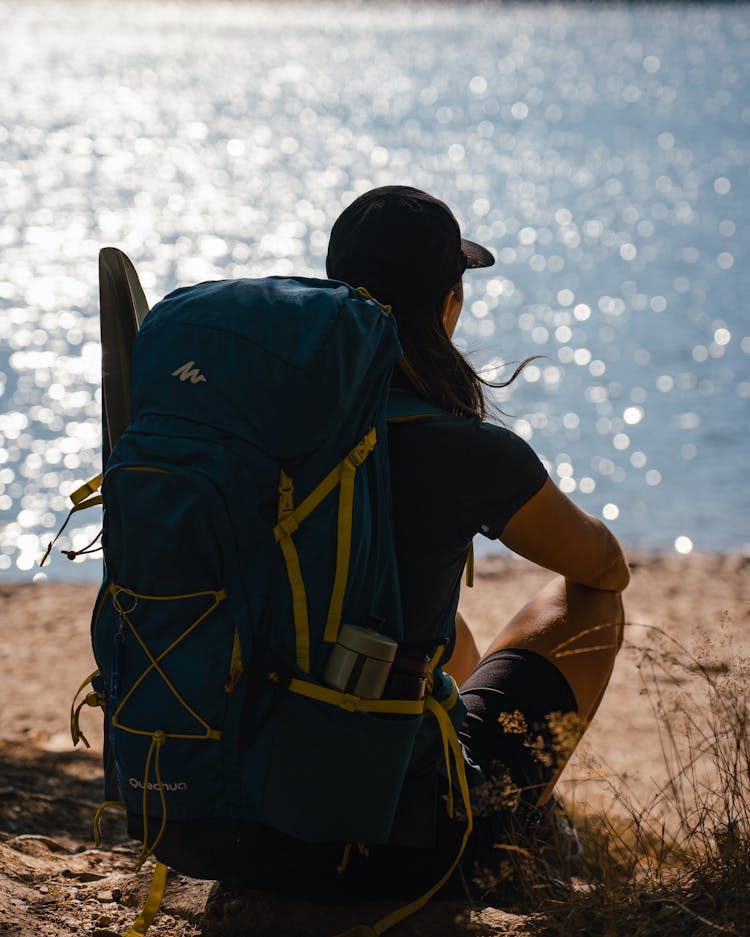 A Person Sitting With Backpack