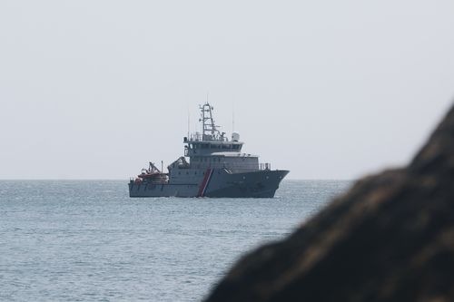 Free A coastguard patrol ship navigating the calm sea off the coast of Bretagne, France, under clear skies. Stock Photo