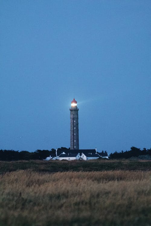 White and Black Lighthouse Under Blue Sky