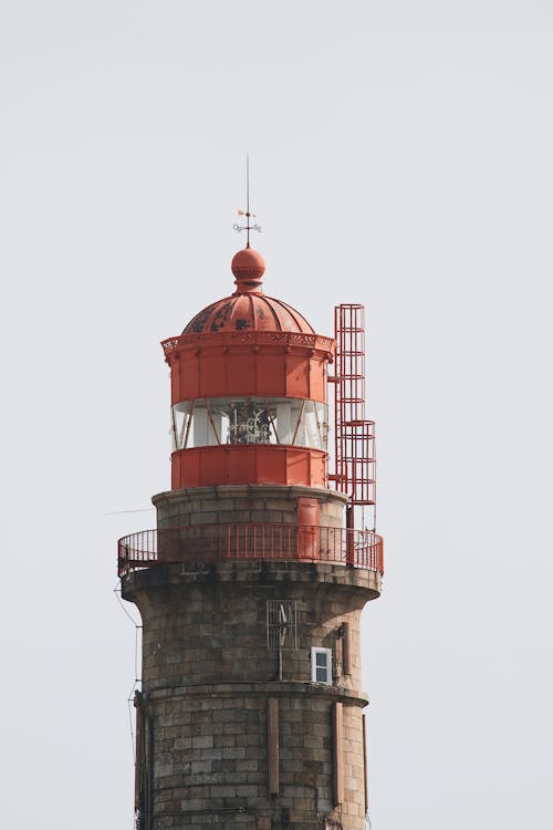 Red and Black Tower Under White Sky