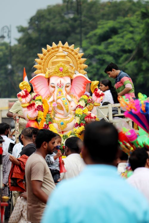 Free Vibrant celebration of Ganesha festival with colorful crowd and ornate statue. Stock Photo