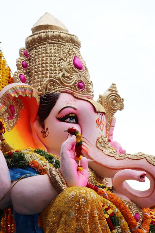 Free Vibrant close-up of a Ganesh statue adorned for a Hindu festival, capturing spiritual essence. Stock Photo