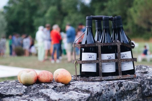 Bottles of Mercurey wine and apples on a rustic setting in Bourgogne, France.