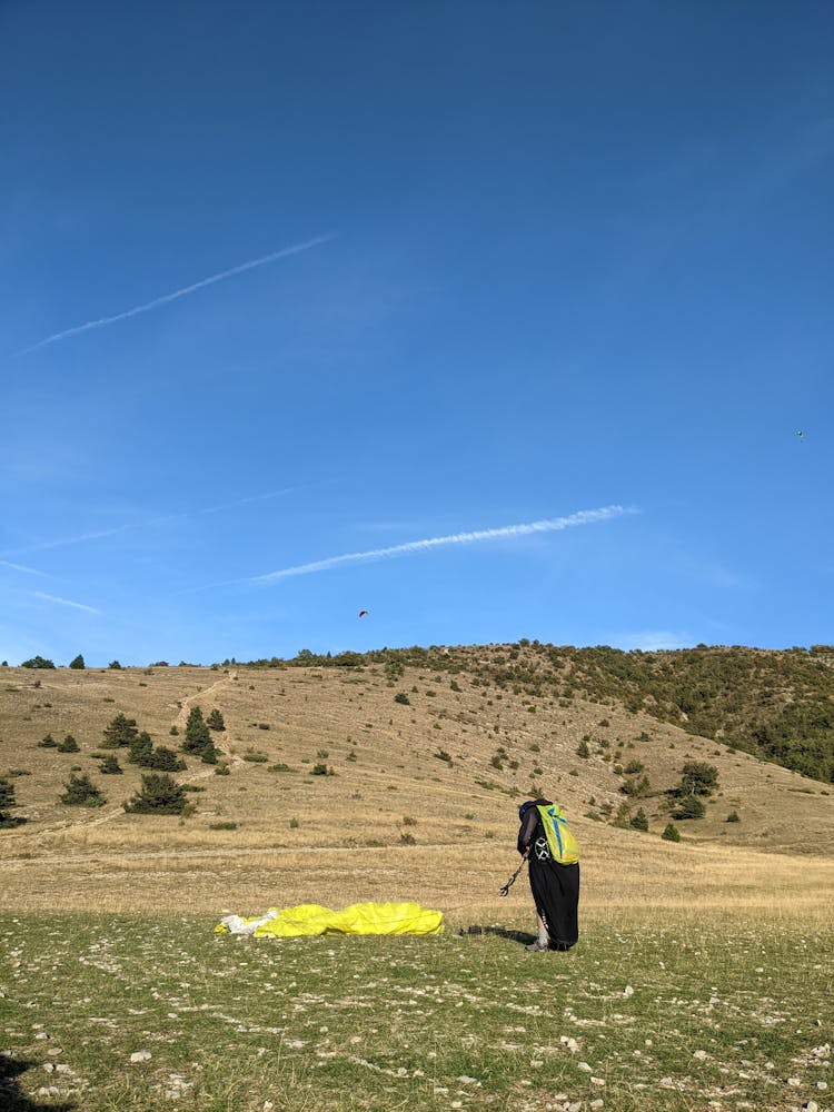 Man With Parachute On Field