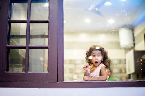 Girl Behind Glass Window