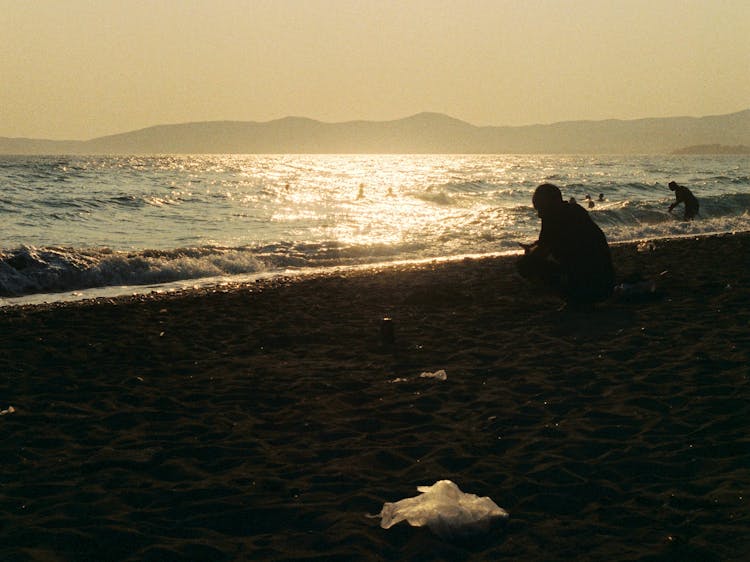 Silhouette Of People On Beach During Sunset